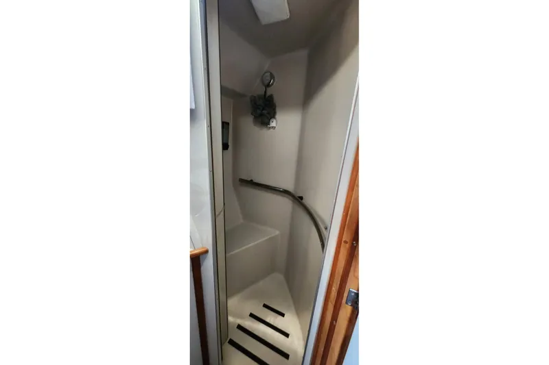 Slide: The Image of 1988 Sea Ray 390 Express Cruiser bathroom with sink and shower. - 34