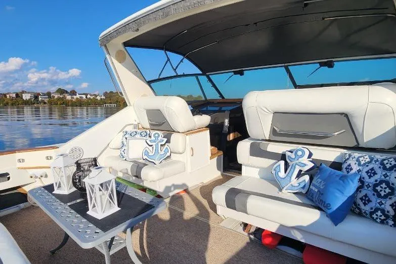 Slide: The Image of 1988 Sea Ray 390 Express Cruiser interior with nautical decor and seating. - 5