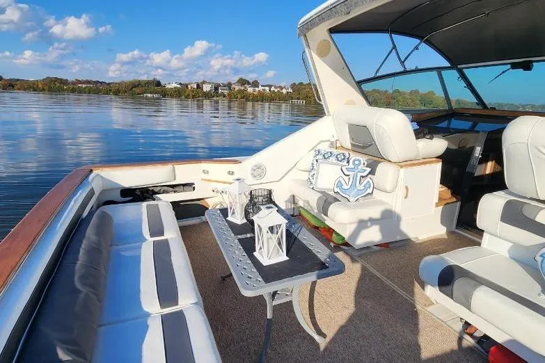 Slide: The Image of 1988 Sea Ray 390 Express Cruiser interior with nautical decor and scenic water view. - 6
