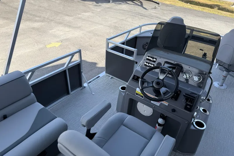 Slide: The Image of Interior view of 2026 Avalon 2385 Venture 85 Center Fish boat, featuring steering console and seating. - 19