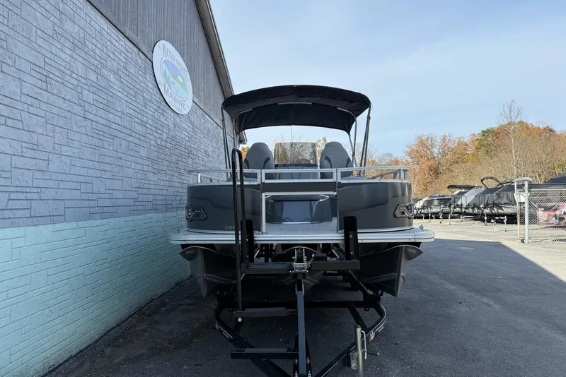 Slide: The Image of 2026 Avalon 2385 Venture 85 Center Fish pontoon boat on trailer, parked outdoors. - 3