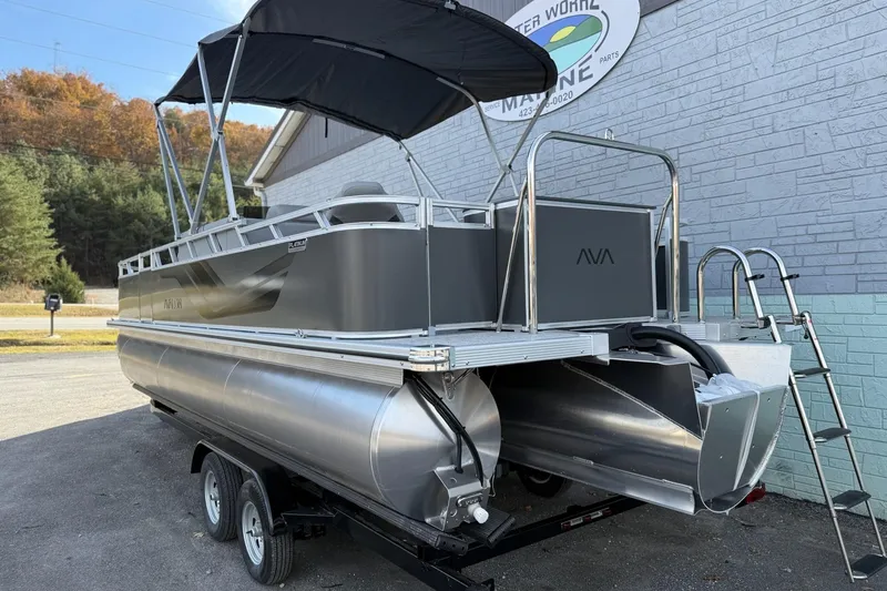 Slide: The Image of 2026 Avalon 2385 Venture 85 Center Fish pontoon boat on trailer, parked outdoors. - 5