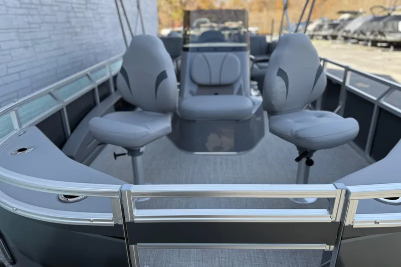 Slide: The Image of 2026 Avalon 2385 Venture 85 Center Fish boat interior with gray seating and sleek design. - 7