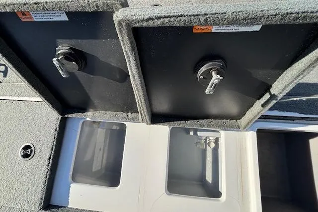 Slide: The Image of Storage compartments on a 2002 Stratus 18xl boat, featuring secure latches and carpeted surfaces. - 11
