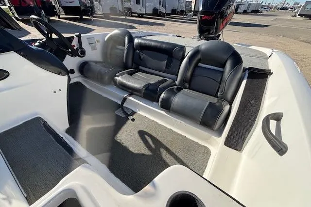 Slide: The Image of 2002 Stratus 18xl boat interior with black leather seats and steering wheel. - 12