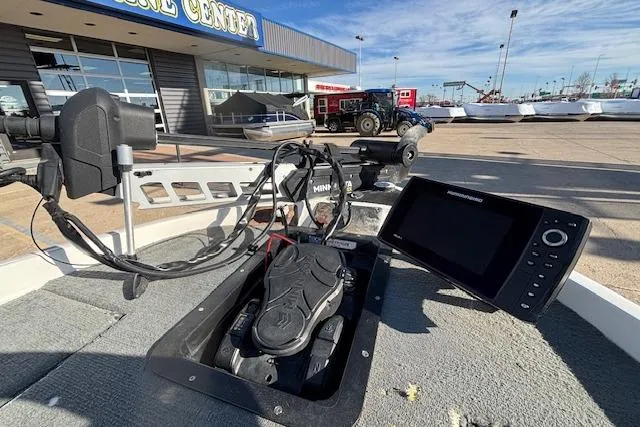 Slide: The Image of Boat deck with electronic equipment, featuring a 2002 Stratus 18xl model at a marine center. - 16