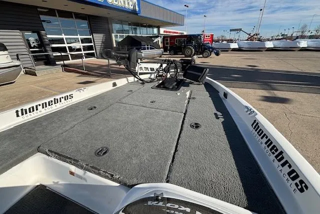 Slide: The Image of 2002 Stratus 18xl boat with fishing deck, parked outside a marine center. - 17
