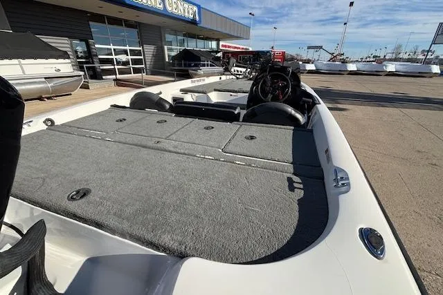 Slide: The Image of 2002 Stratus 18xl boat at a marine center, showcasing spacious deck and seating. - 20