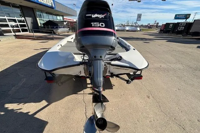 Slide: The Image of 2002 Stratus 18xl boat with Yamaha VMAX 150 outboard motor, parked outdoors. - 21
