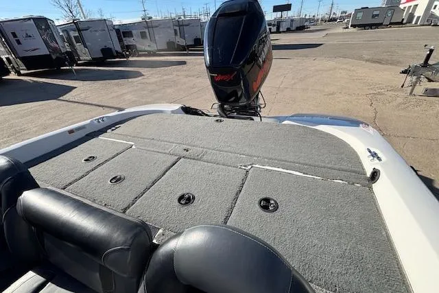 Slide: The Image of 2002 Stratus 18xl boat with outboard motor, parked in a lot with trailers. - 5