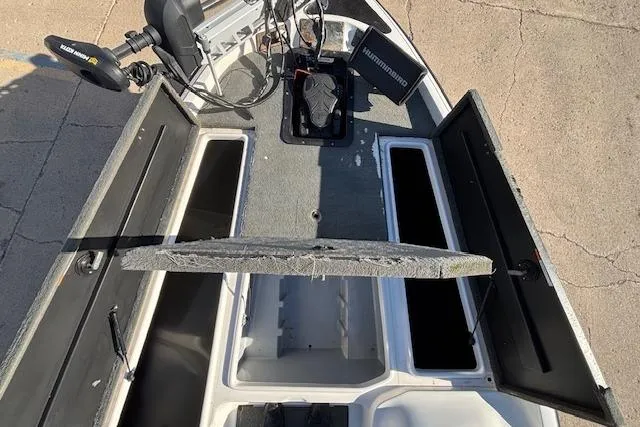 Slide: The Image of 2002 Stratus 18xl boat interior with open storage compartments and fishing equipment. - 8