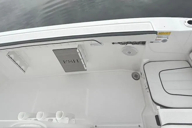Slide: The Image of 2024 Yamaha Boats 222 FSH Sport E interior, featuring seating and storage compartments. - 11