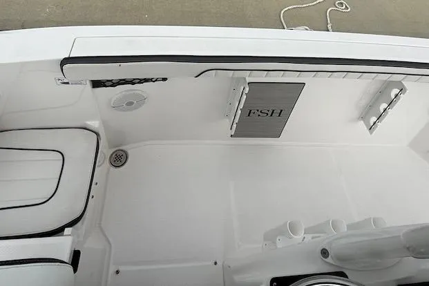 Slide: The Image of 2024 Yamaha Boats 222 FSH Sport E interior deck with seating and storage. - 12