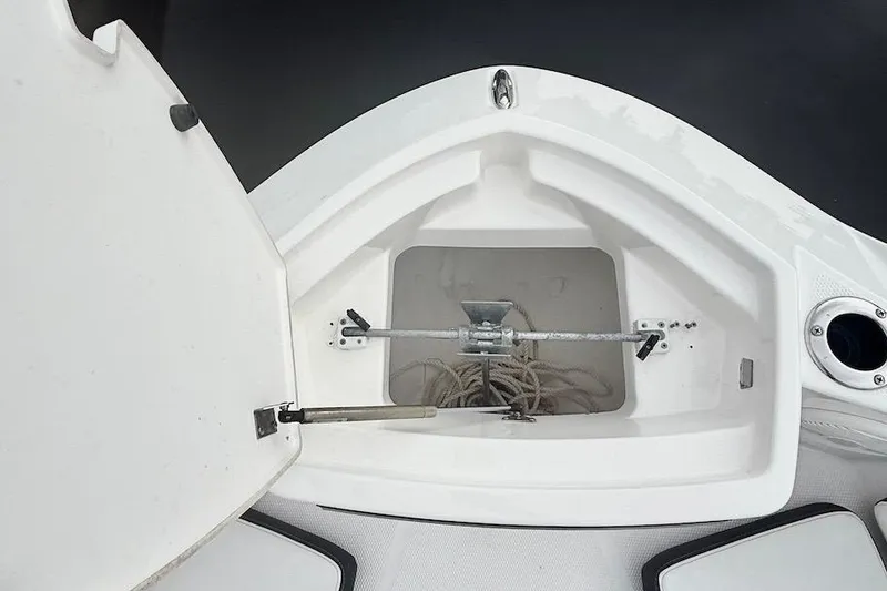 Slide: The Image of 2024 Yamaha Boats 222 FSH Sport E anchor storage compartment with open hatch. - 14