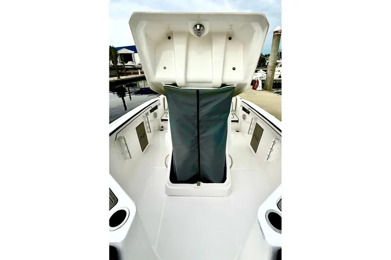 Slide: The Image of 2024 Yamaha Boats 222 FSH Sport E, open storage compartment, docked at marina. - 17