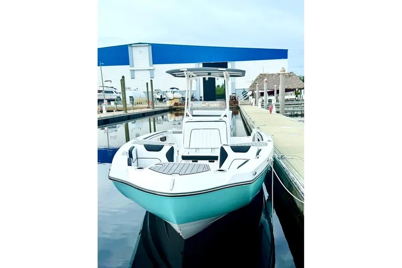 Slide: The Image of 2024 Yamaha Boats 222 FSH Sport E docked at marina, showcasing sleek design. - 2