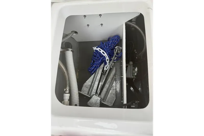 Slide: The Image of Storage compartment of 2024 Yamaha Boats 222 FSH Sport E with anchor and rope. - 22