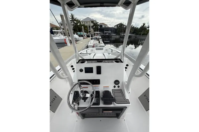 Slide: The Image of 2024 Yamaha Boats 222 FSH Sport E helm, featuring modern controls and steering wheel. - 23