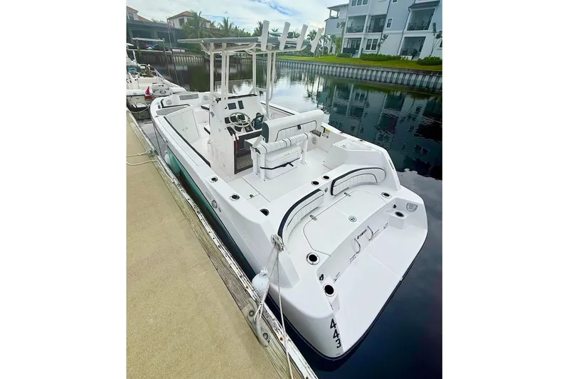 Slide: The Image of 2024 Yamaha Boats 222 FSH Sport E docked by waterfront homes. - 7