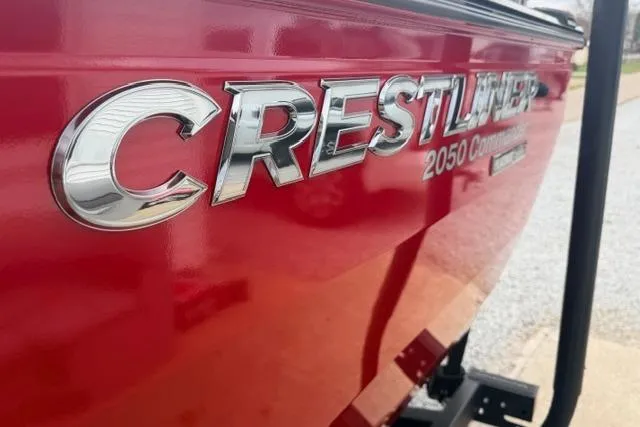 Slide: The Image of Red 2026 Crestliner 2050 Commander boat with chrome lettering on the side. - 12