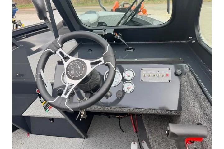 Slide: The Image of 2026 Crestliner 2050 Commander boat dashboard with steering wheel and control panel. - 5