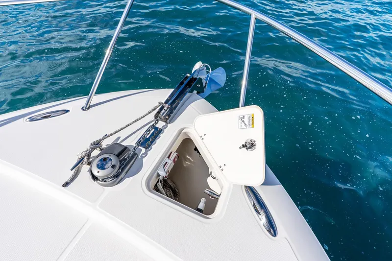 Slide: The Image of 2024 Boston Whaler 405 Conquest bow with anchor and open hatch on blue water. - 13
