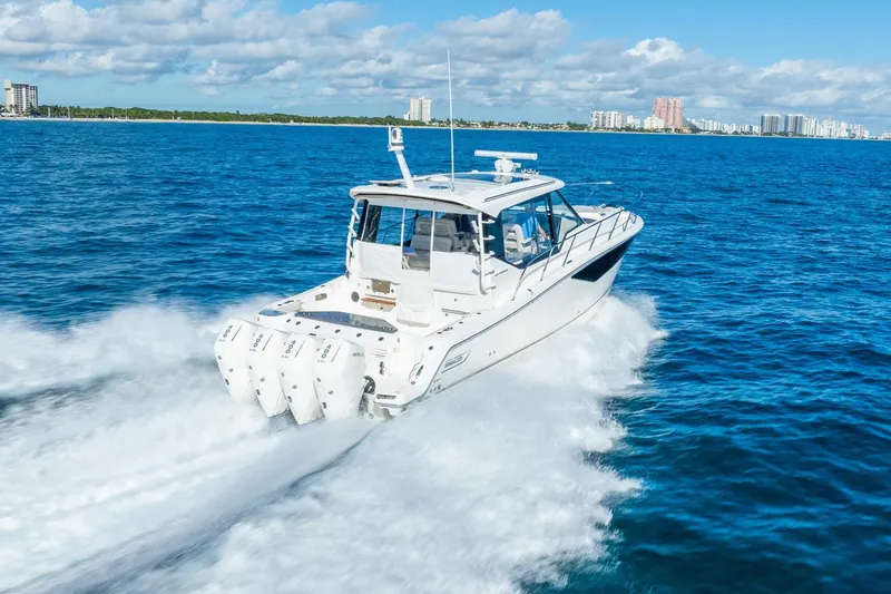 Slide: The Image of 2024 Boston Whaler 405 Conquest cruising on open blue ocean waters. - 2