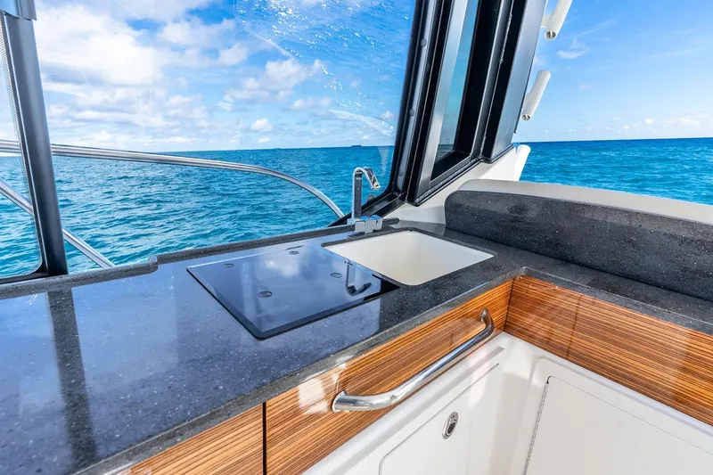 Slide: The Image of Luxurious 2024 Boston Whaler 405 Conquest yacht kitchen with ocean view. - 23