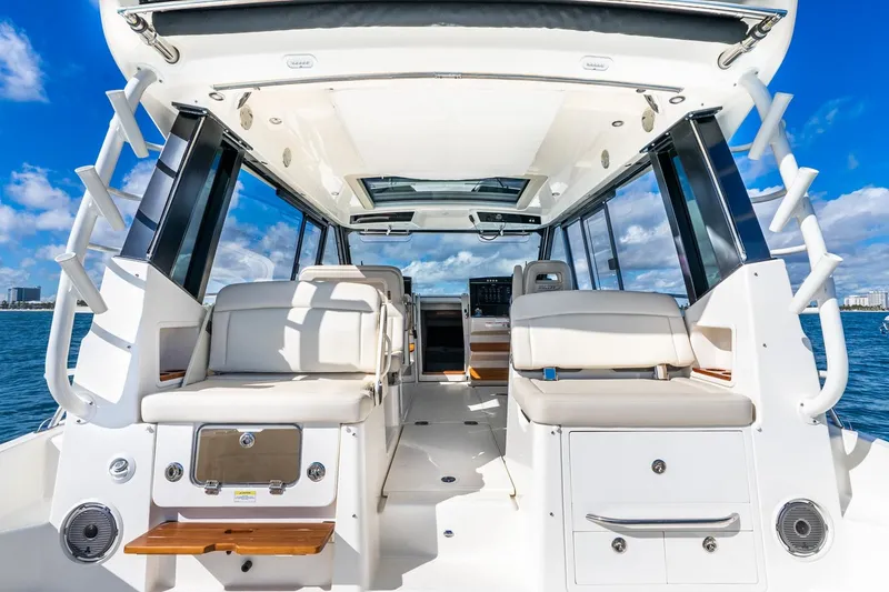 Slide: The Image of 2024 Boston Whaler 405 Conquest interior with seating, ocean view, and clear skies. - 25