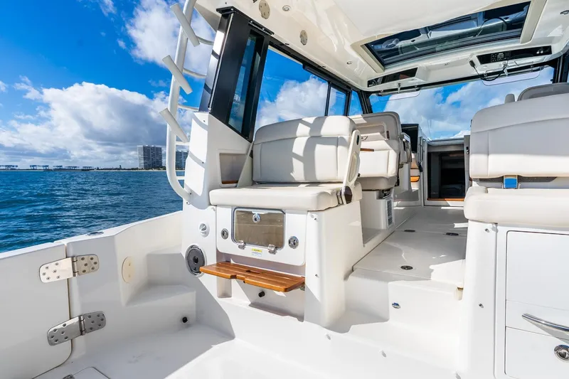 Slide: The Image of 2024 Boston Whaler 405 Conquest boat interior with luxurious seating and ocean view. - 26