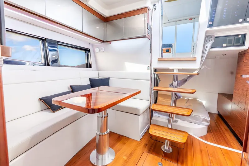 Slide: The Image of Luxurious interior of 2024 Boston Whaler 405 Conquest with elegant seating and wooden accents. - 28