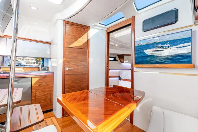 Slide: The Image of Luxurious interior of 2024 Boston Whaler 405 Conquest yacht with wood finishes and modern amenities. - 29
