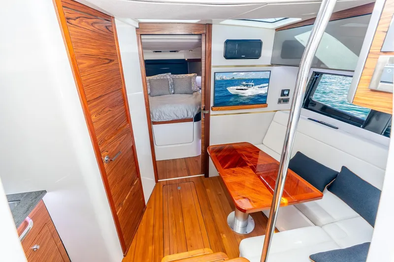Slide: The Image of Luxurious interior of 2024 Boston Whaler 405 Conquest yacht with wood accents and cozy seating. - 30