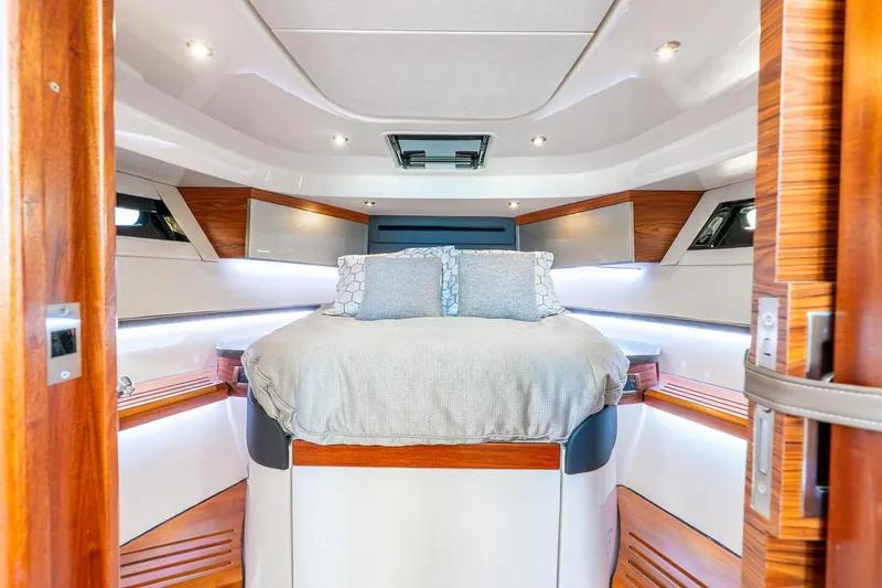 Slide: The Image of Luxurious cabin interior of 2024 Boston Whaler 405 Conquest yacht with elegant bedding. - 31
