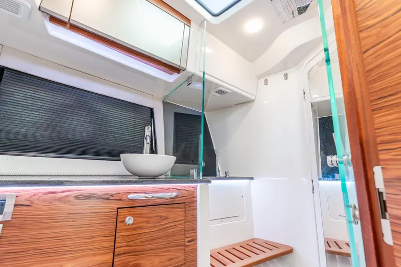 Slide: The Image of Luxurious interior of 2024 Boston Whaler 405 Conquest boat, featuring modern bathroom design. - 34