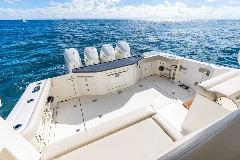 Slide: The Image of 2024 Boston Whaler 405 Conquest boat deck with ocean view and multiple engines. - 38
