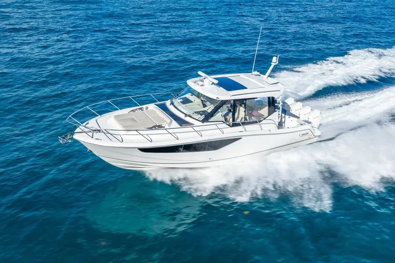 Slide: The Image of 2024 Boston Whaler 405 Conquest cruising on open blue waters. - 4