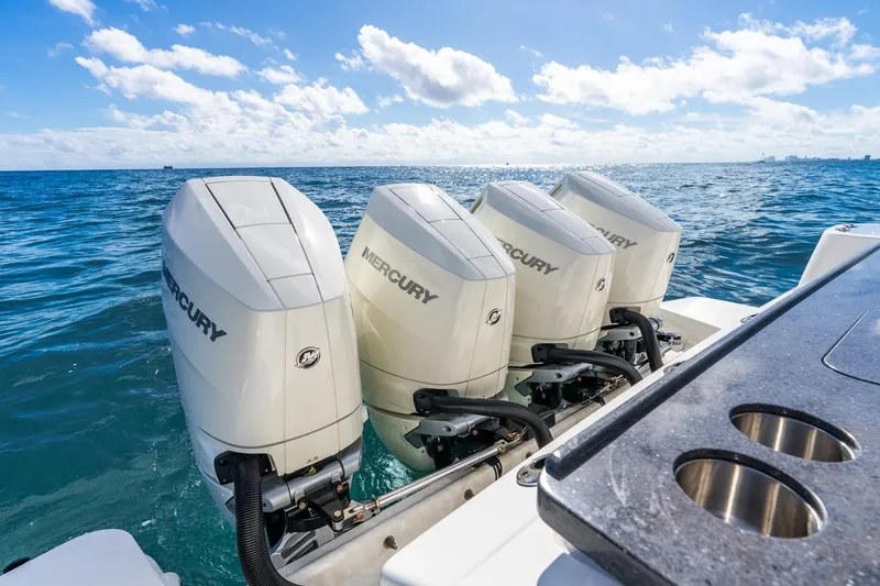 Slide: The Image of Four Mercury outboard engines on a 2024 Boston Whaler 405 Conquest in open water. - 42