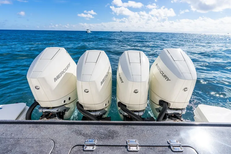 Slide: The Image of Four Mercury outboard engines on a 2024 Boston Whaler 405 Conquest in open ocean. - 43