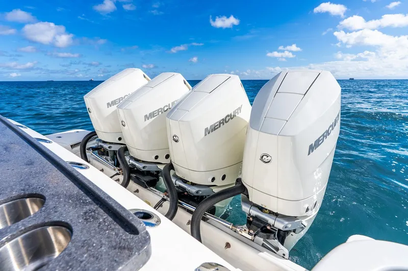 Slide: The Image of Four Mercury outboard engines on a 2024 Boston Whaler 405 Conquest in open sea. - 44