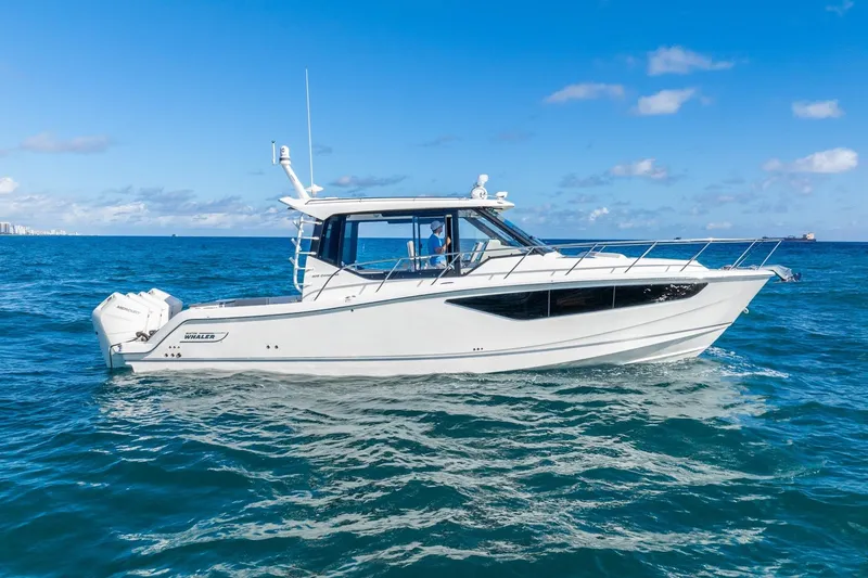 Slide: The Image of 2024 Boston Whaler 405 Conquest boat cruising on open blue ocean. - 7