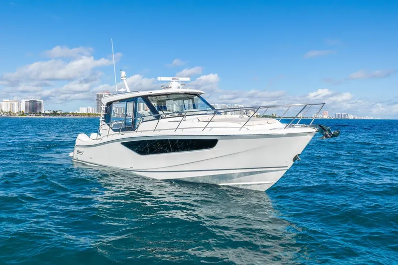 Slide: The Image of 2024 Boston Whaler 405 Conquest boat on blue ocean with city skyline background. - 8