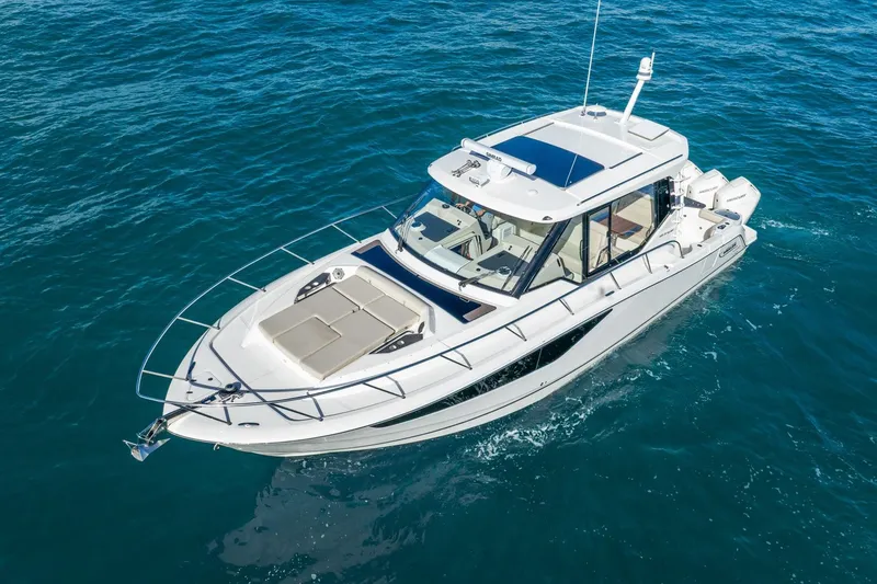 Slide: The Image of 2024 Boston Whaler 405 Conquest cruising on open water, showcasing sleek design and luxury features. - 9
