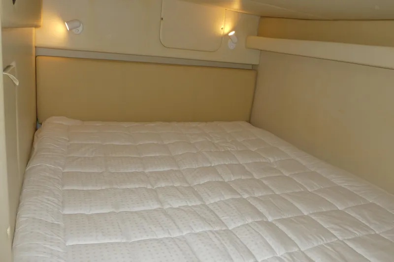 Slide: The Image of Interior cabin of 2007 Bayliner 325 with cozy bed and soft lighting. - 28