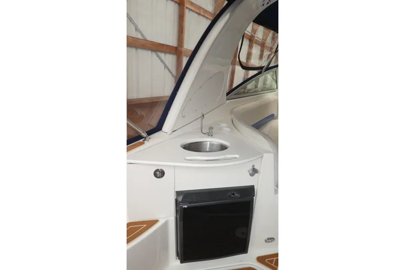 Slide: The Image of 2007 Bayliner 325 boat interior with sink and mini fridge. - 32