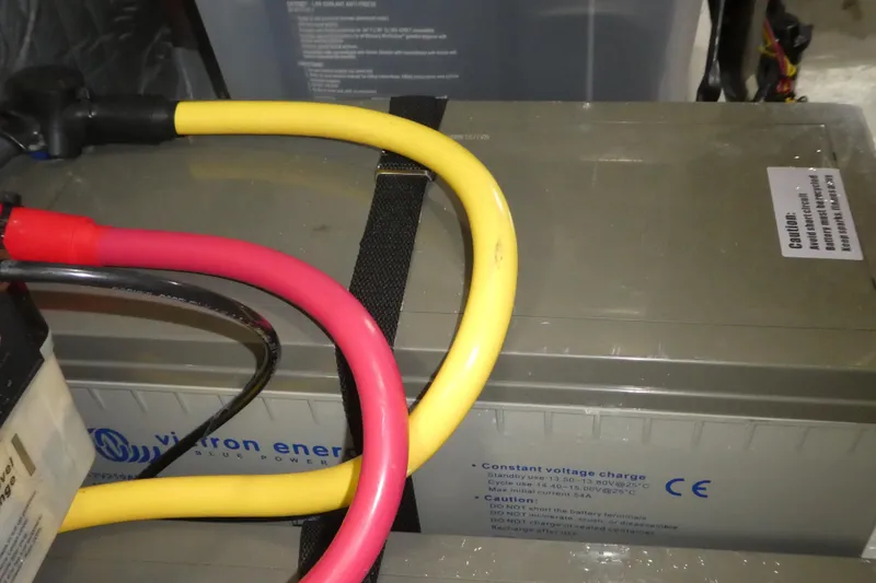 Slide: The Image of Battery setup in a 2007 Bayliner 325 boat with colorful cables and caution label. - 41