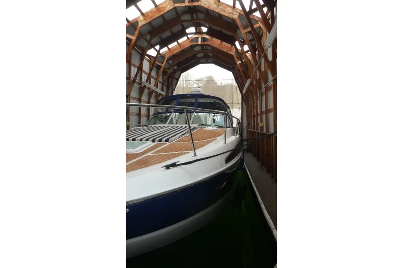 Slide: The Image of 2007 Bayliner 325 boat docked in a wooden boathouse. - 43