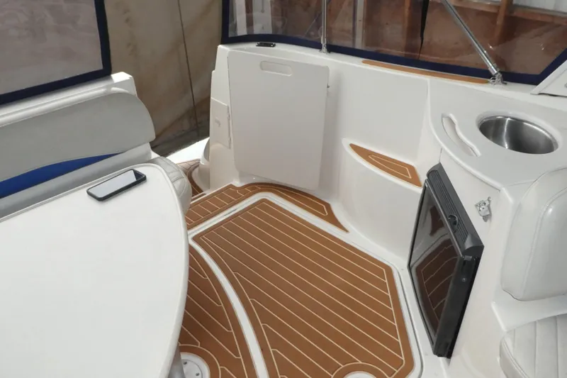 Slide: The Image of 2007 Bayliner 325 boat interior with seating, table, and sink. - 8