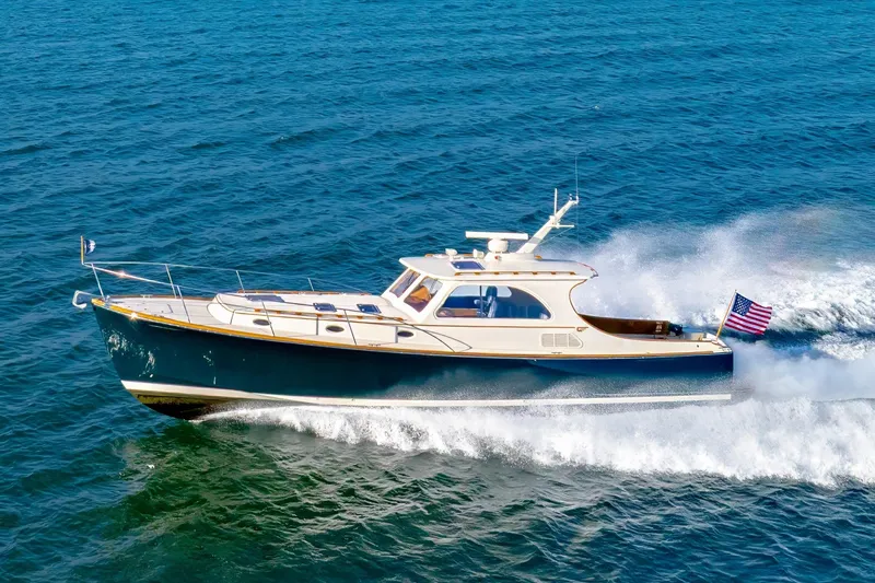 The Image of Hinckley Talaria 44 Express 1999 cruising on open water, certified pre-owned. - 0