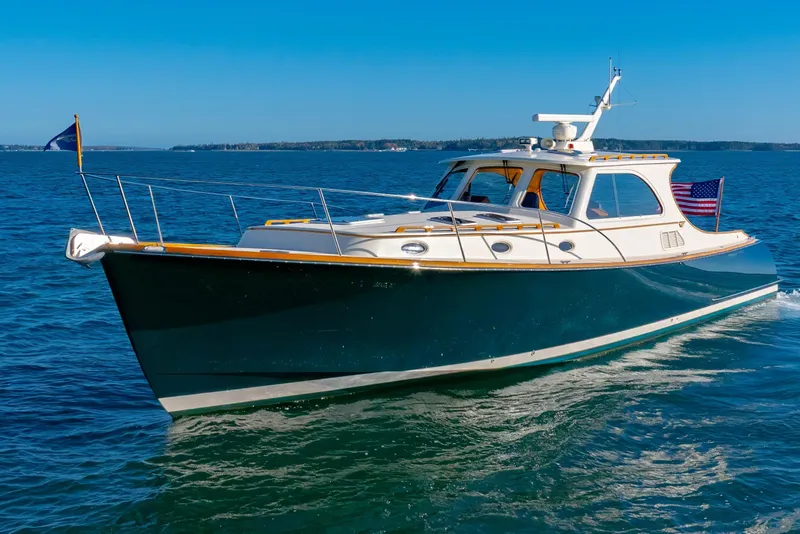 Slide: The Image of 1999 Hinckley Talaria 44 Express yacht cruising on open water. - 11